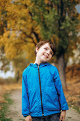 Cute smiling boy in blue jacket posing outdoors in autumn park stock photo © sergo321