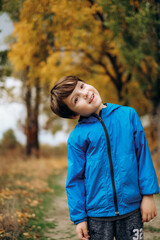 Cute smiling boy in blue jacket posing outdoors in autumn park stock photo © sergo321