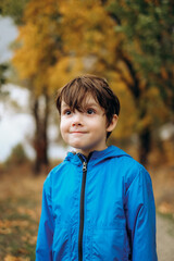 Cute smiling boy in blue jacket posing outdoors in autumn park stock photo © sergo321