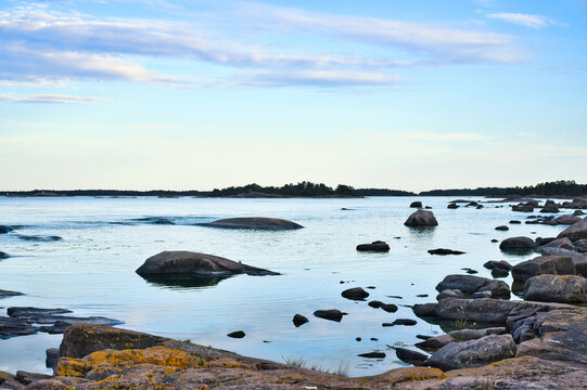 Rocky Skerry Landscape by Calm Sea Under Soft Evening Sky. In Sweden, Darvik.