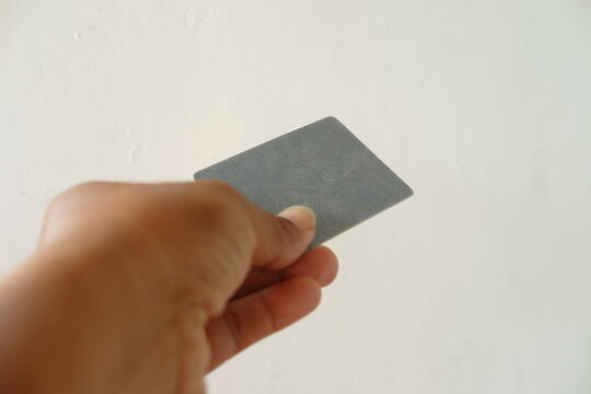 Close up of hand holding blank white business card with copy space