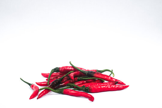 Fresh red chili peppers on white background