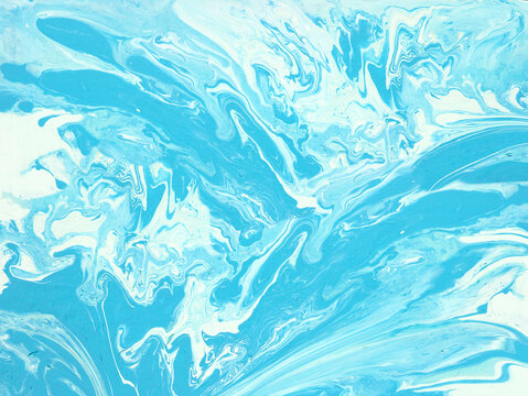 Abstract  blue fluid art background with dynamic splashes and swirls of acrylic paint.