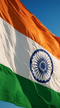 National flag of India waving in blue sky.