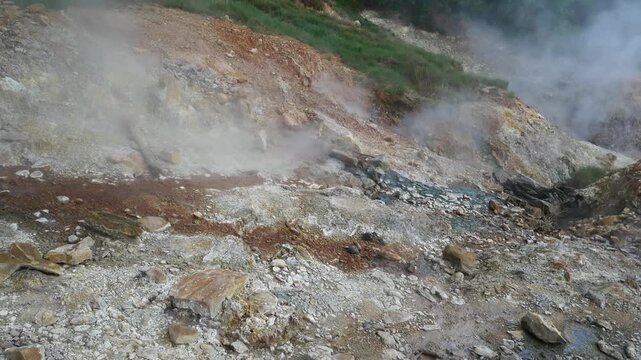 Geothermal springs in Tuscany, Italy, with mineral-rich rocks, steaming ground, and vivid green thermal deposits, showcasing volcanic activity, natural energy, and unusual landscape formations