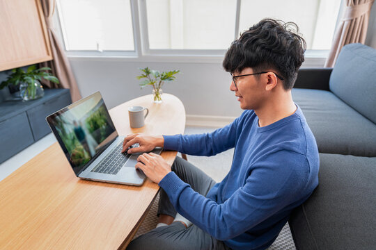 Asian man in casual clothes, typing on laptop about new business