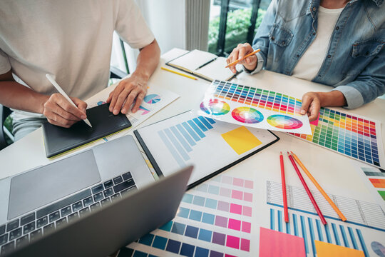 Two creative graphic designer team working on color selection an