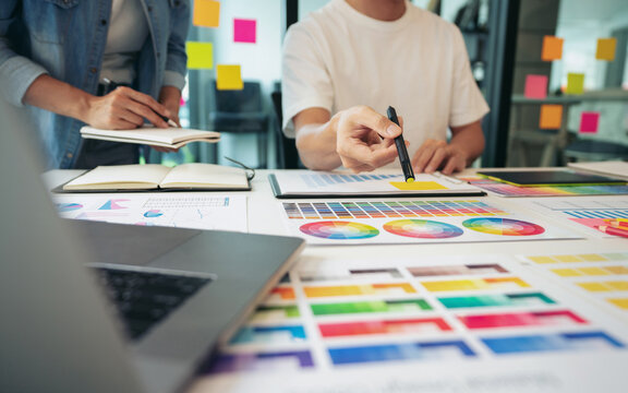Two creative graphic designer team working on color selection an