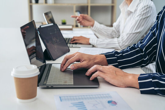 Business trader team are using laptop to checking stock market o
