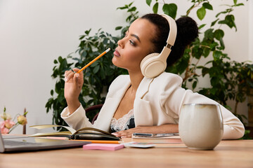 An African American businesswoman reflects while working in her stylish office