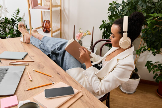 Young African American businesswoman relaxes while jotting down ideas in her office