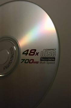 Compact disc CD with colorful light reflections, vintage digital media technology