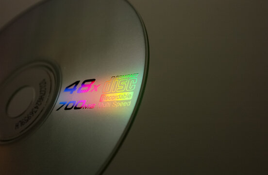 Compact disc CD with colorful light reflections, vintage digital media technology