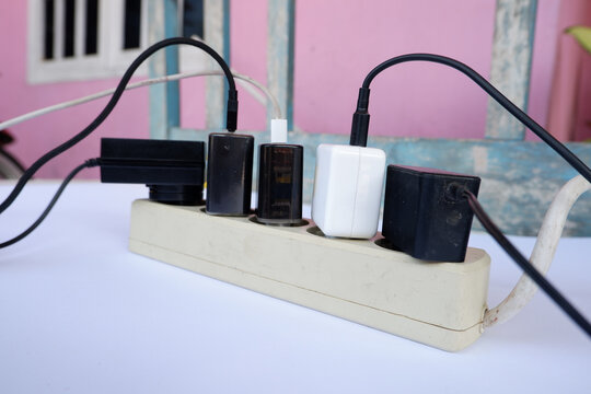 Overloaded Power Strip with Multiple Chargers and Plug Adapters