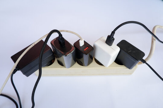 Overloaded Power Strip with Multiple Chargers and Plug Adapters
