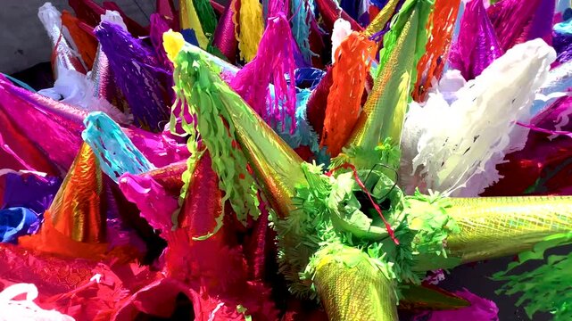 Handmade Mexican pi&ntilde;atas displayed in vibrant local market