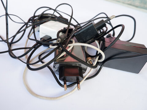 Tangled Cable Mess with Power Adapters and Chargers for Electronic Devices Concept