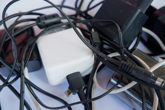 Tangled Cable Mess with Power Adapters and Chargers for Electronic Devices Concept