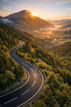 Winding mountain road at sunrise in the Alps.