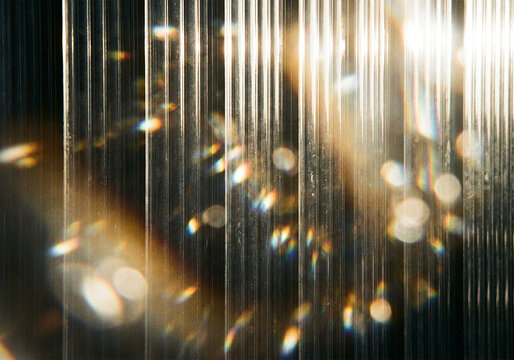 Abstract vertical lines with golden light leaks and soft bokeh lens flare background