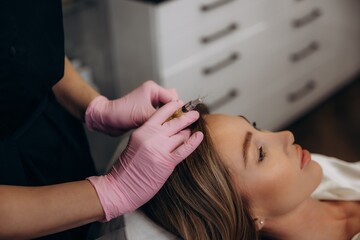Woman receiving prp hair mesotherapy injections for hair loss