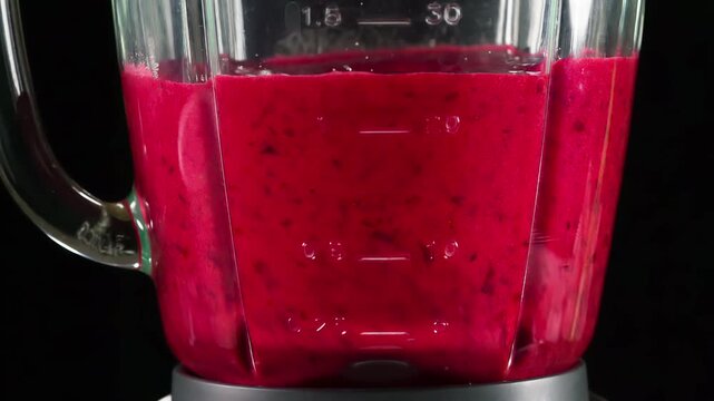 Grinded Berries for Jam. Grinded cranberries slowly rotate in a running blender closeup