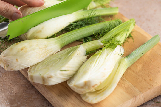 Fresh Florence fennel bulbs or Fennel bulb cutting on board