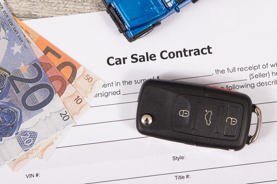 Car sale contract, euro banknotes, blue toy car and black key. Sales, purchases of vehicle