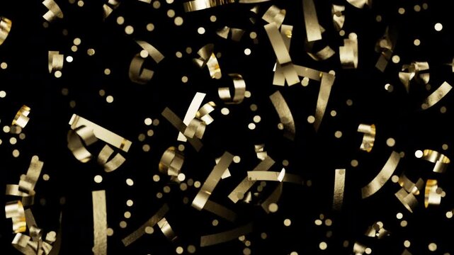 Golden confetti and sparkling bokeh particles falling on black