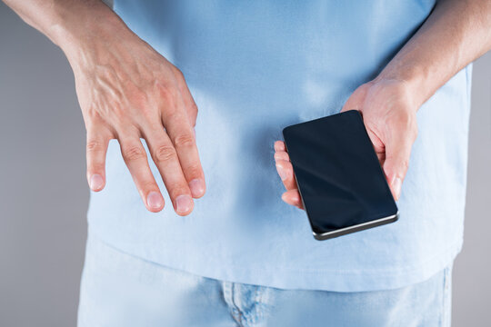 Pain in little finger from holding mobile phone in your hand for too long. Smartphone syndrome, social media addiction and excessive screen time
