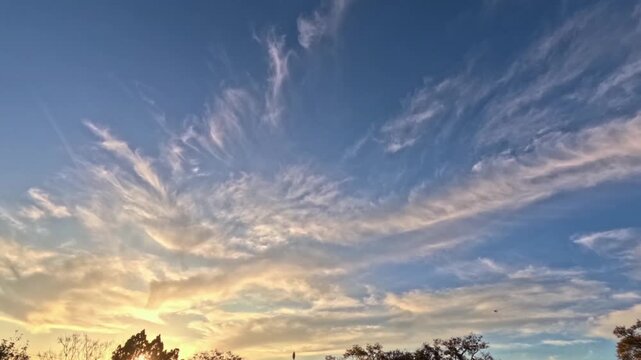 The stunning evening sky presents a blend of bright blue hues and the golden glow of the setting sun. 