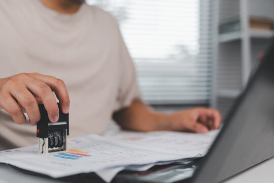 financial analysis and business performance review. professional using laptop and examining financial reports, charts, and key metrics for strategic corporate decision making.