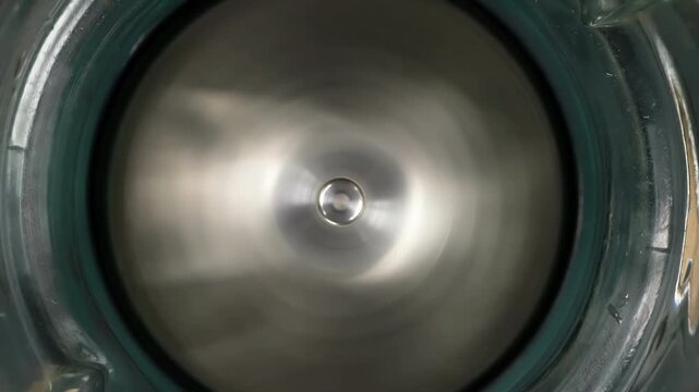 Sharp Blender Rotating Blades. Acute blender blades rotate inside a glass beaker close up