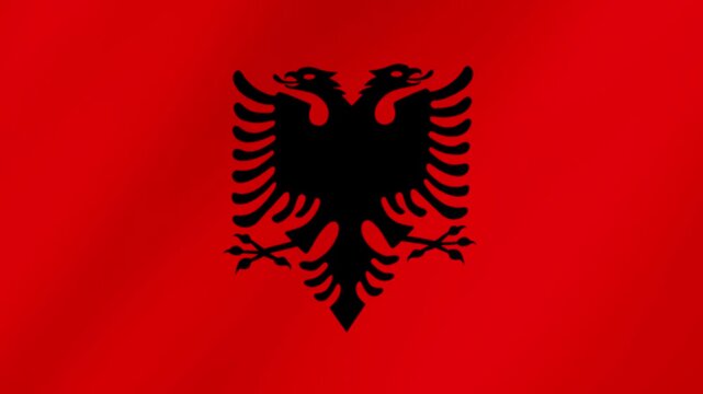 National flag of albania with the black double-headed eagle on a red background. The fabric texture creates a realistic waving motion