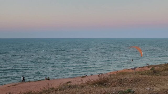 Paraglider Flying Over Ocean Cliffs at Sunset, Canoa Quebrada, Brazil
