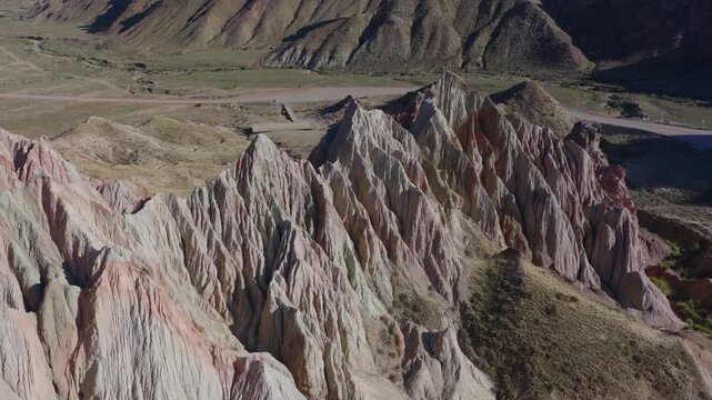 Aerial view of colorful Danxia landform, exotic rocky peaks in Zhangye, Gansu, China
Drone shot of magnificent alien‑valley rock formations, multicolored mountain landscape under blue sky