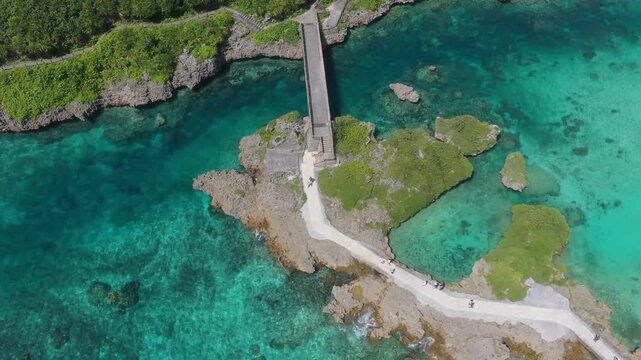 Horizontal cameo trucking left while facing right from a lateral angle over the turquoise coastal waters near Shigira, Miyako, Okinawa, Japan