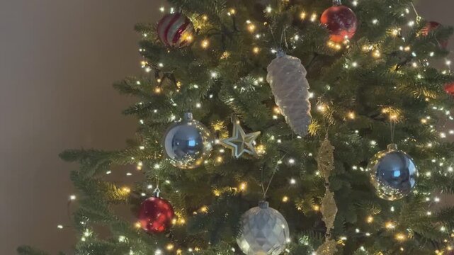 Close up view of decorated Christmas tree with glowing lights and ornaments. Perfect festive background. 