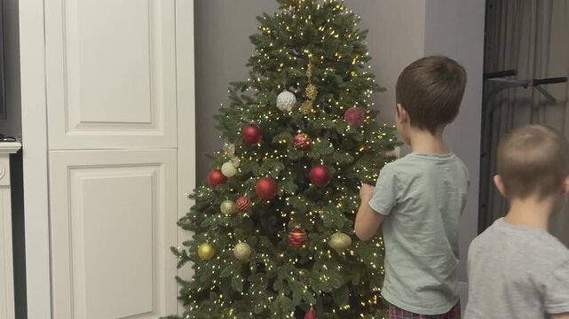  Kids take ornaments from box getting ready to decorate Christmas tree. Preparation phase before celebration. Great for holiday storytelling and retail ads. 
