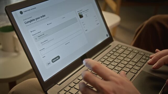 Unrecognizable customer entering payment card credentials to complete online purchase on laptop. Footage fits e-commerce advertising, fintech campaigns, and digital payment promotions