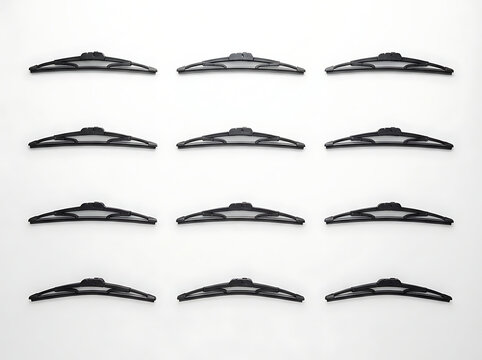 Set of black windshield wipers arranged in a grid pattern on a white background.