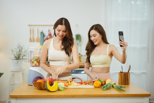 Lifestyle use lets women tie affection and embracing to friends around produce beside the blender, while lifestyle use lets women tie affection and embracing to friends by a smartphone on the island.