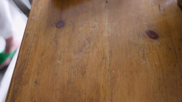4K close-up video of a baking tin lined with parchment paper filled with raw sponge cake batter.