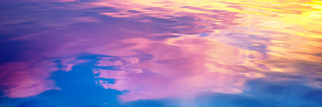 Seascape at sunset light. Calm sea water with clouds and sun reflection. Abstract nature landscape background. Gradient color