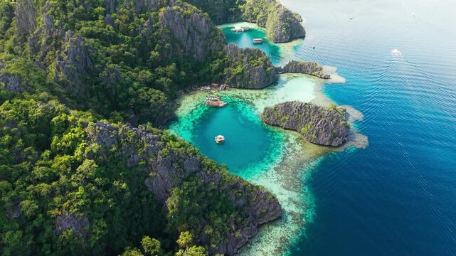 Drone flies forward, turquoise lagoons in Coron Island Protected Area, Palawan