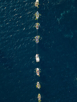 Fasinada Boats Linked In A Line convoy, top down drone shot