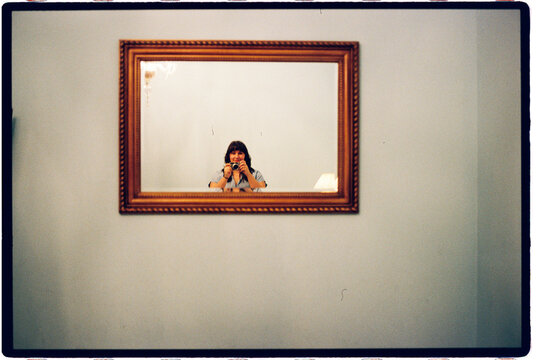 Woman taking selfie in mirror