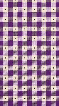 Purple gingham fabric pattern background with small polka dots
