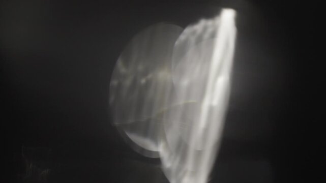Ethereal light leak effect with natural camera lens flare and soft spectral bokeh over black. Designed for seamless screen-mode blending, transitions, and mood creation.