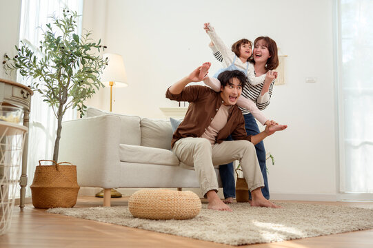 Family Plays Together in a Living Room on a Sofa